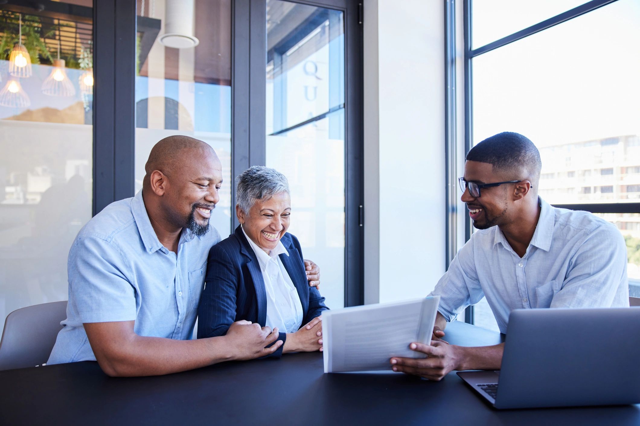 Smiling mature couple meeting with a financial advisor in an office