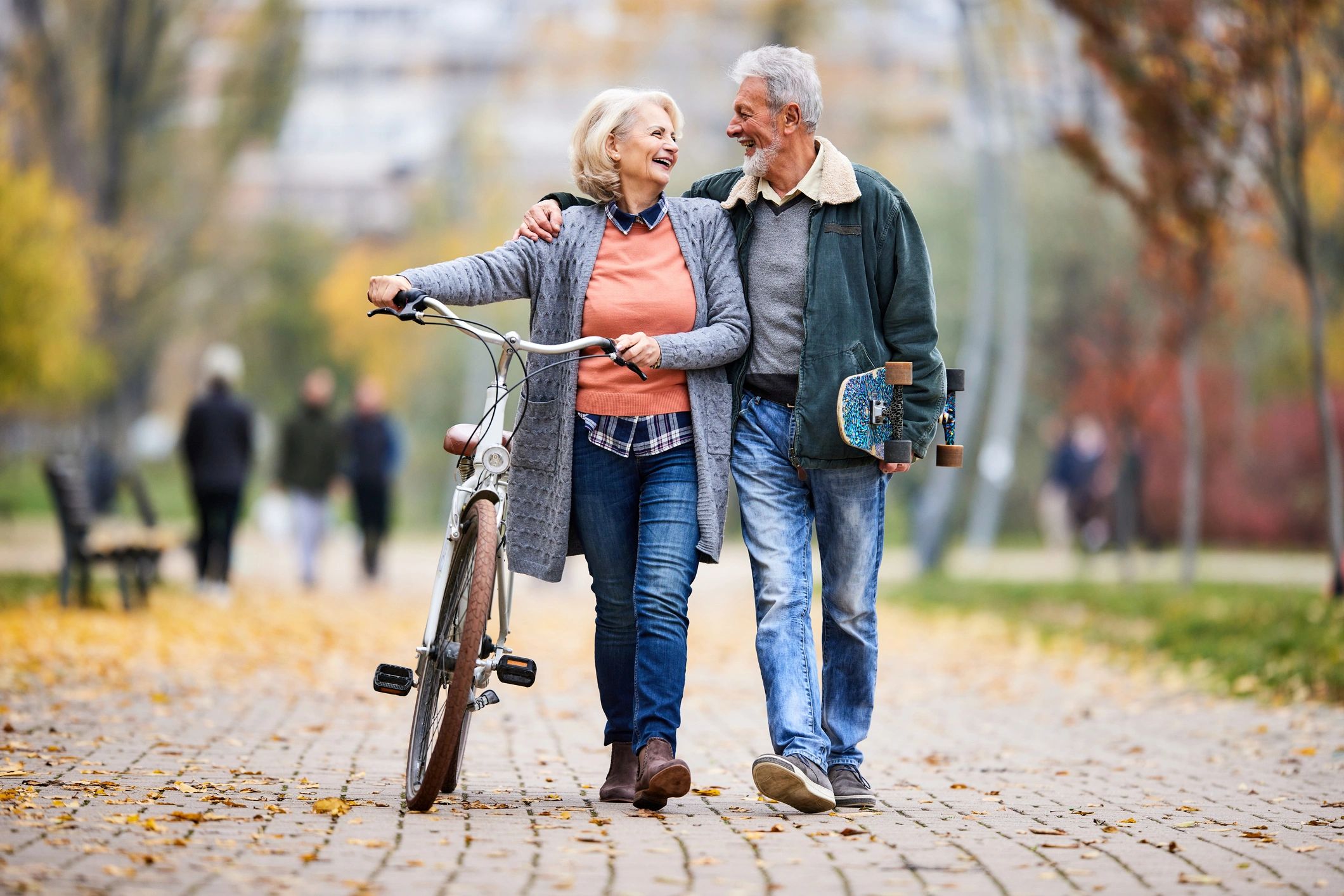 Happy senior couple enjoying an autumn walk, representing confident retirement planning