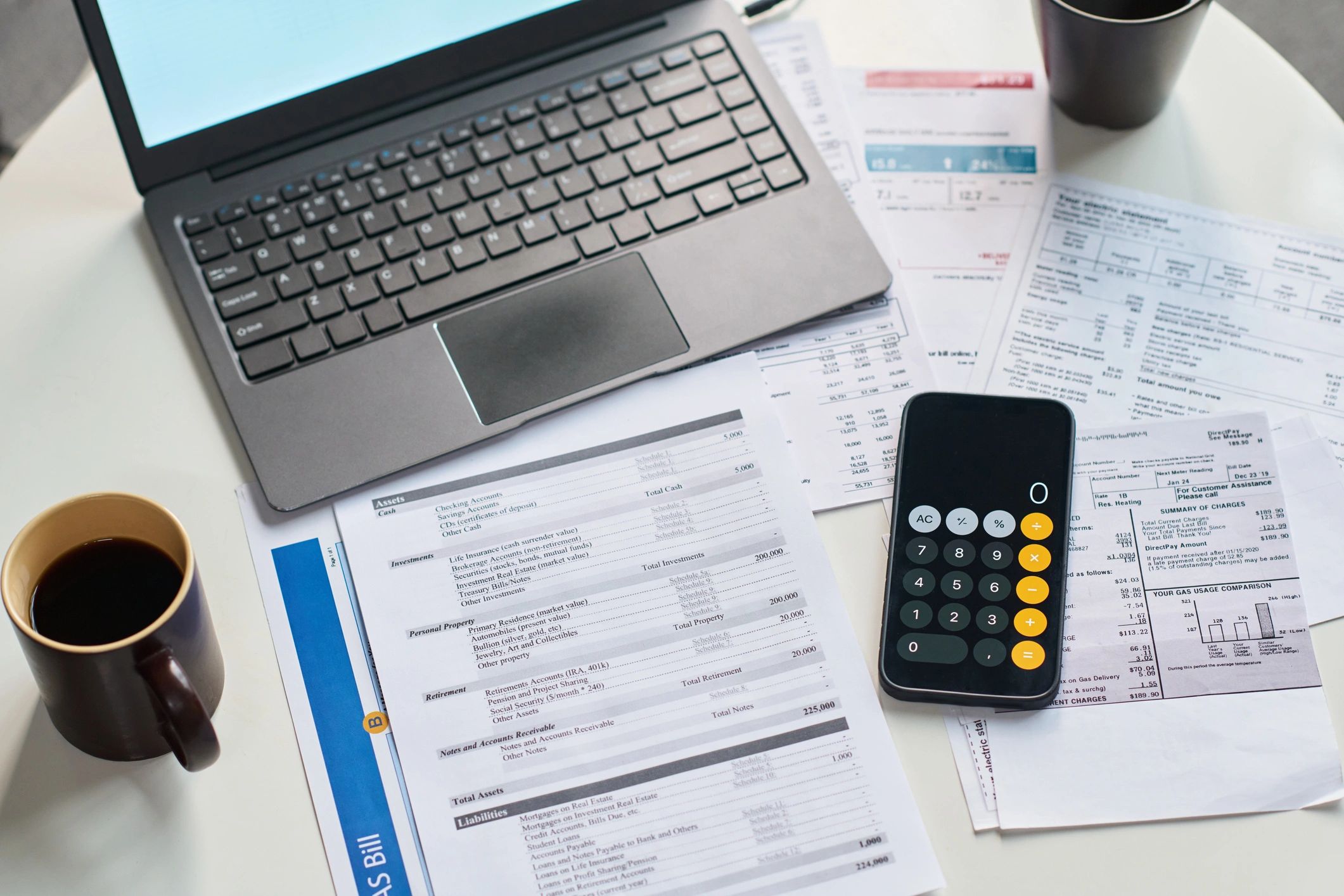 Laptop, calculator and tax documents on a table